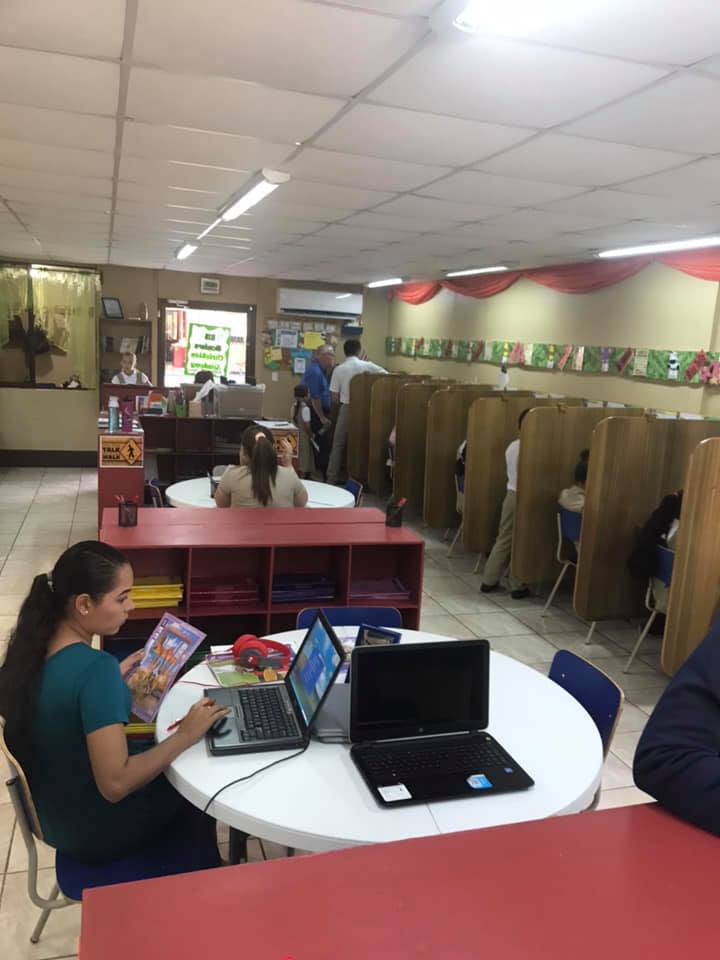 Students studying with laptops in the His Wonders Christian Academy classroom in Costa Rica